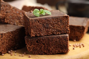 Delicious chocolate puffed rice bars and mint on wooden table, closeup