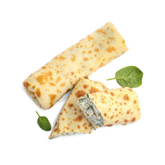 Tasty rolled crepes with cottage cheese and spinach isolated on white, top view