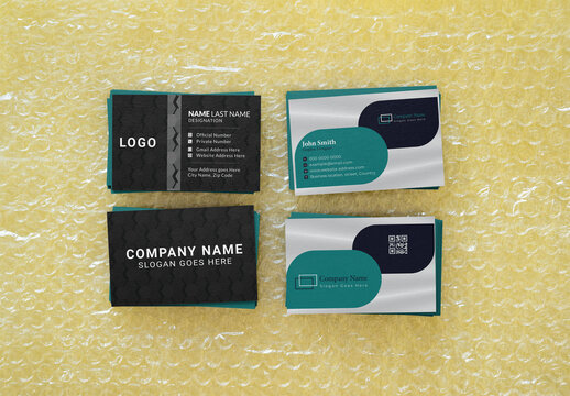 Four business cards are showcased with front and back view, resting on bubble wrap