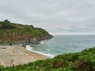 Fototapeta premium Arnielles Beach and San Agustín Lighthouse, Ortiguera, Asturias, Spain
