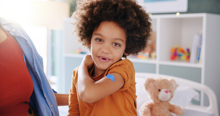 Boy, portrait and kid in clinic, plaster and vaccine with healthcare, support and injection. Hospital, child and patient with bandage, medical help or first aid with wellness, immunisation or smile
