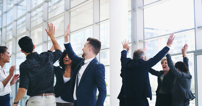 Collaboration, celebration and high five with business people in lobby of office for company goals or target, Motivation, success and winner with employee team cheering for bonus, deal or good news - Powered by Adobe