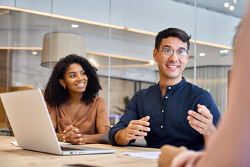 Happy young executive professional manager discussing project plan with diverse business team...