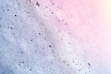 Obraz premium Close-up of a textured surface with small holes and a soft pink gradient.