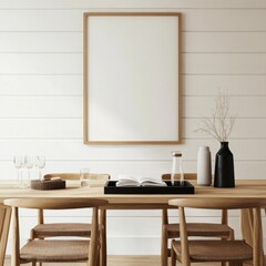 A white framed picture hangs on a wall. The picture is empty. A table with four chairs is in front of the picture. A vase with flowers sits on the table