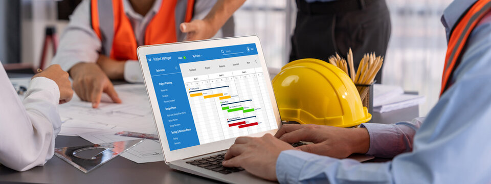 Project planning software for brisk business project management on the computer screen showing timeline chart of the team project