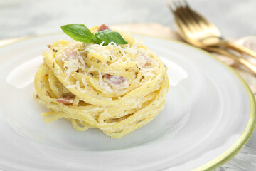 Plate with delicious pasta Carbonara on table, closeup