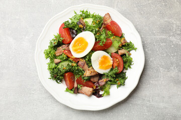 Delicious fresh tuna salad on grey textured table, top view