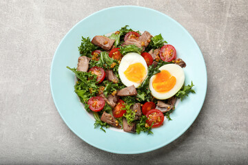 Delicious fresh tuna salad on grey textured table, top view