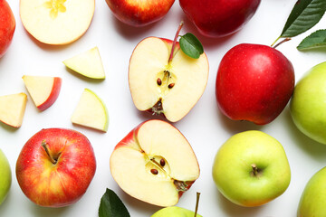 Flat lay composition with whole and cut apples on white background