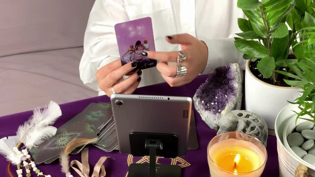 Online tarot consultation - two female hands showing and reading tarot cards through video call