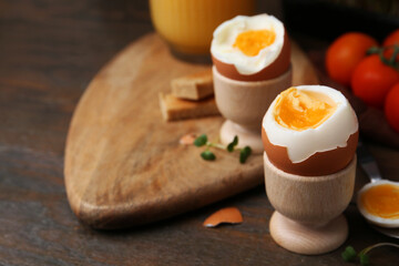 Soft boiled eggs on wooden table, closeup. Space for text