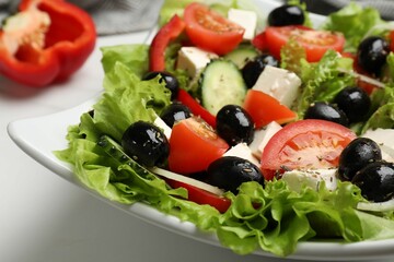 Delicious fresh Greek salad on white table, closeup