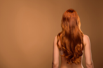 Fototapeta premium Photo of lovely attractive lady back view curly hair nude body isolated on beige color background