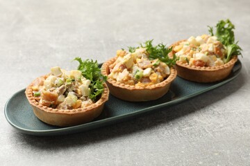 Tartlets with delicious filling on grey table, closeup