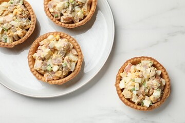 Tartlets with delicious filling on white marble table, top view
