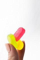 closeup on white background in women's fingers caramel candies green pink yellow a lot of sugar development of diabetes and caresses sweets for children