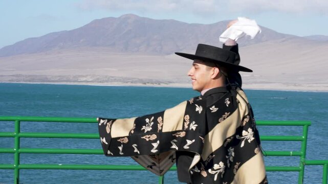 Chilean dancers perform cueca, their national dance, with handkerchiefs by a lake
