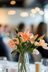 A speaker giving a presentation with the audience and event space in the background blurred, focused on a business event