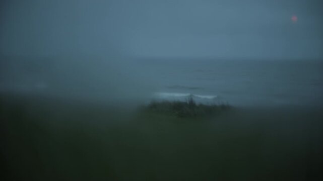 View of foggy coastline through bus window