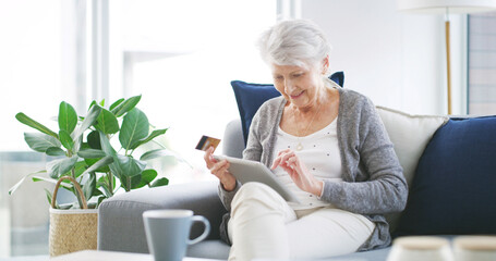 Happy, old woman and tablet with credit card on sofa for online shopping, subscription payment or discount sale. Ecommerce, senior person and app for debit transaction and customer experience in home