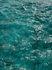 blue water surface texture with sun reflection