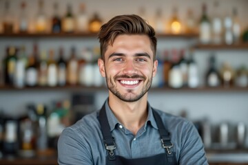 Naklejka premium portrait of a young smiling Slovak male bartender against blurred bar background
