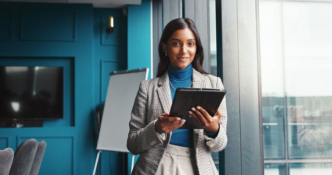 Portrait, confident and woman with tablet, window and online for financial report in office and smile. Corporate, accountant and person with tech for tax filing, app and info for profit of business - Powered by Adobe