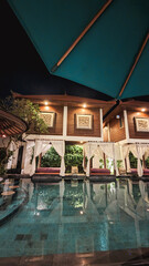 Luxurious Poolside Retreat at Night with Cabanas