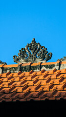 Intricate Roof Ornament Against a Blue Sky