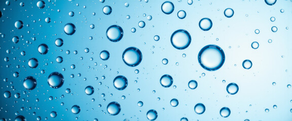 water droplets on glass with a refreshing mood representing purity against a blue background