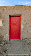 Rustic Adobe House with Bold Red Door