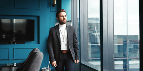 Window, business and man in office, thinking and solution with decision for investment deal. Person, broker and accountant in workplace, daydreaming and financial advisor with choice and New York