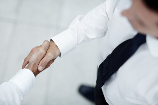 Above, meeting and business people with handshake for agreement, introduction and corporate deal. Office, employees and accountants with shaking hands for welcome, partnership and teamwork success