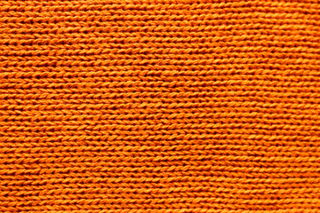 Horizontal orange coloured knitted texture as a backdrop.