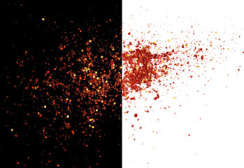 Spicy chili red pepper flakes, chopped, milled dry paprika scattered, isolated on white and black,...