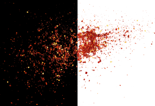 Spicy chili red pepper flakes, chopped, milled dry paprika scattered, isolated on white and black, top view	