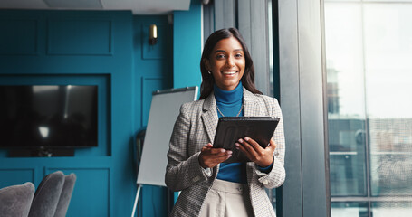 Portrait, smile and tablet with business Indian woman in boardroom of corporate office for...