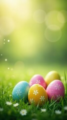 Colorful Easter eggs hiding in green grass on blurred background. Easter landscape. Spring background with copy space for greeting card, banner, poster, wallpaper