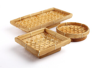 A set of handcrafted bamboo baskets in different shapes displayed on a white background, showcasing traditional weaving patterns and natural materials suitable for product or craft themes.