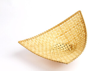 A handmade bamboo woven basket displayed on a white background, showcasing its natural texture and craftsmanship of traditional Indonesian design.