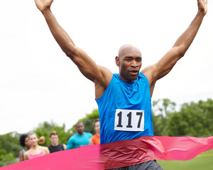 Fitness, winner and black man on track for race, challenge or marathon for charity fundraising. Sports, runner and African athlete cheering by finish line for cardio workout, exercise or training.