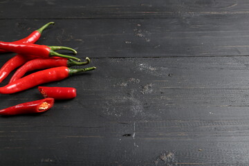Fresh Red Chili Peppers on Black Wooden Background