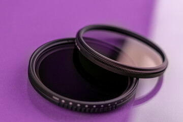 Camera lens filters on reflective purple background