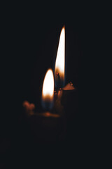 Black candles on a black background. Magical black candles.Candle Flames in Dark Setting. Dark mood. Fortune telling and magic attribute.Magical and witchcraft atmosphere.