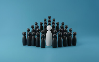 A single white figure stands out amongst a group of black figures.
