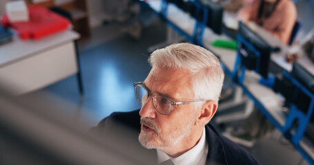 University, lecturer and man in classroom, education and share information with knowledge. Mature...
