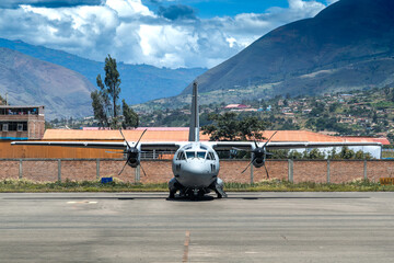 Military airplane with engines off parked in Huanuco, Perú airport, waiting for MEDEVAC mission.