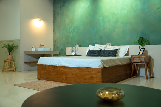 bed in asthetic ambience with green background
