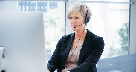 Computer, headset and mature business woman in office for consulting, proposal and project or...